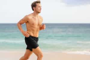 Man running on the beach after low testosterone treatment in Chicago