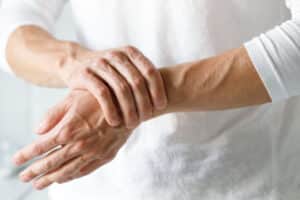 Woman holding her hands due to neurological concerns in Chicago