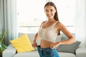 Woman in jeans celebrating weight loss with HCG in Chicago, IL