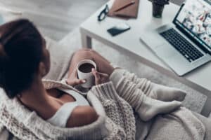 Woman at home on sofa researching PRP for Women's Sexual Health in Chicago